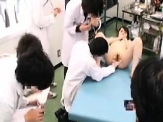 Slim Oriental cutie has a group of doctors examining her ha