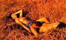 The soft hay makes a perfect bed for these horny teen